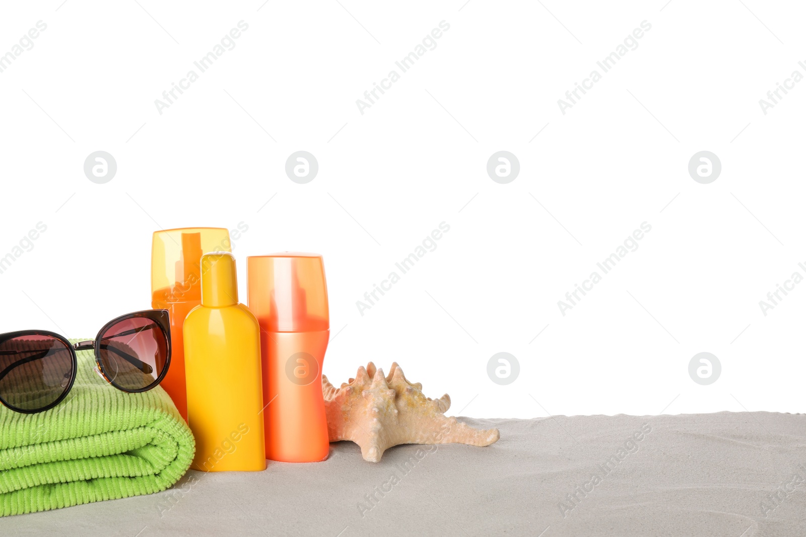 Photo of Composition with sun protection products on sand against white background. Space for text