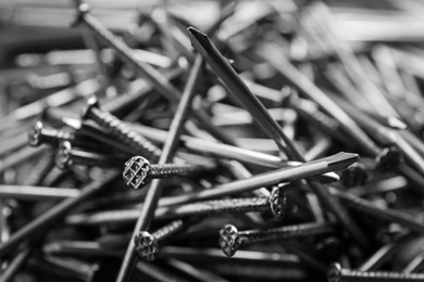 Photo of Pile of metal nails as background, closeup