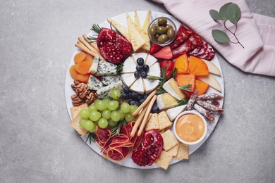 Assorted appetizers served on light grey table, flat lay
