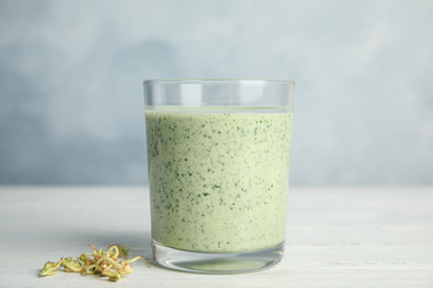 Photo of Green buckwheat smoothie on white wooden table