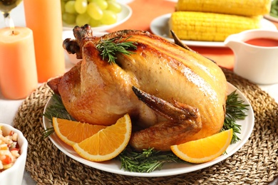 Delicious roasted turkey with garnish on dinner table