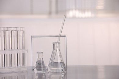 Laboratory analysis. Different glassware with liquid on white table indoors, space for text
