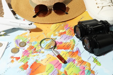 Photo of Different items on world map. Travel during summer vacation