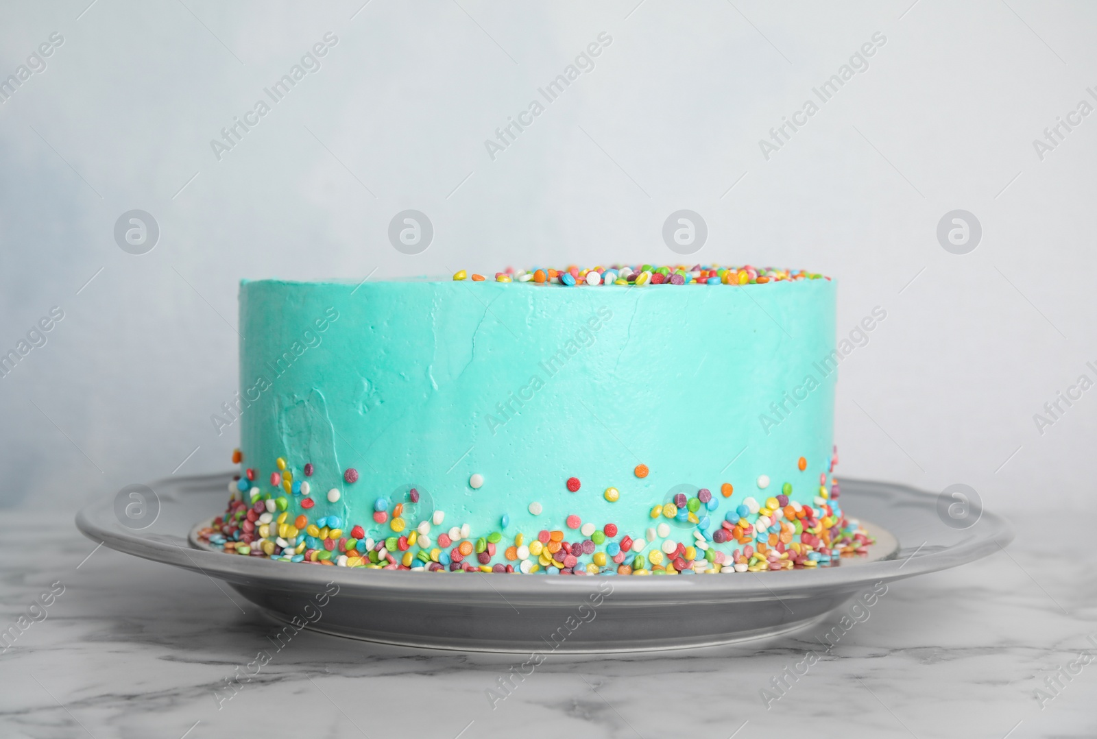 Photo of Plate with fresh delicious birthday cake on table against color background