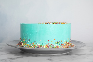 Photo of Plate with fresh delicious birthday cake on table against color background