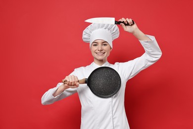 Photo of Professional chef with frying pan and knife having fun on red background
