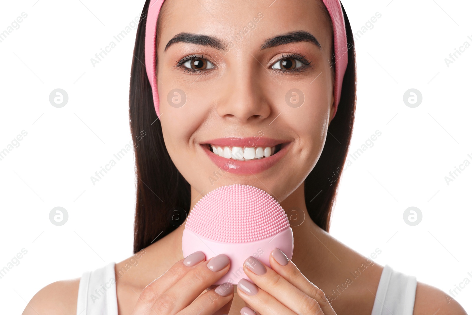 Photo of Young woman using facial cleansing brush on white background, closeup. Washing accessory