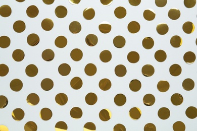 Photo of Shiny golden confetti on white background, flat lay