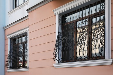 Photo of Beautiful windows with grills in building outdoors