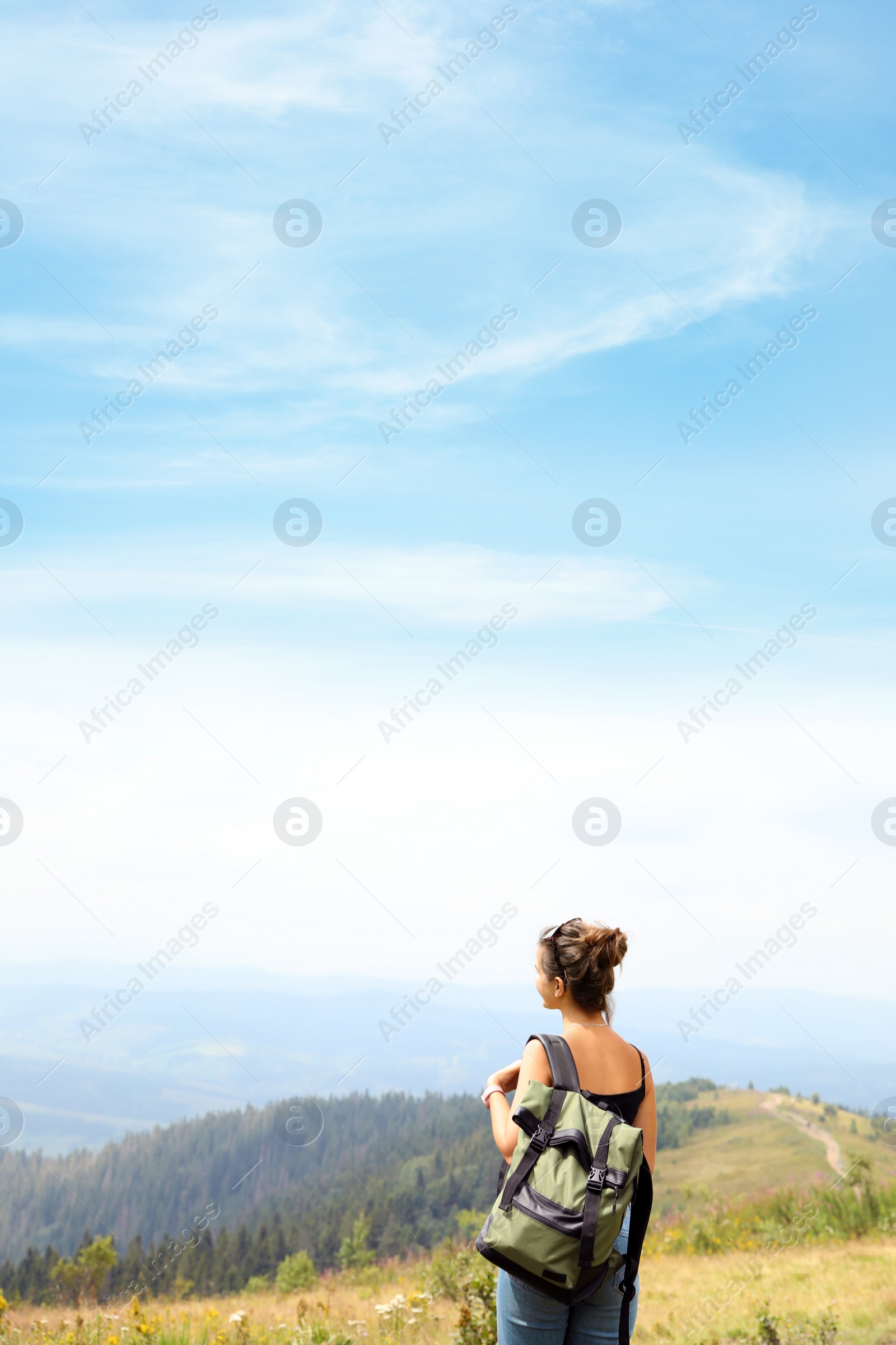 Photo of Woman with backpack in wilderness on cloudy day