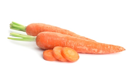 Photo of Whole and sliced ripe carrots on white background