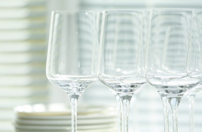 Photo of Set of empty wine glasses on blurred background, closeup