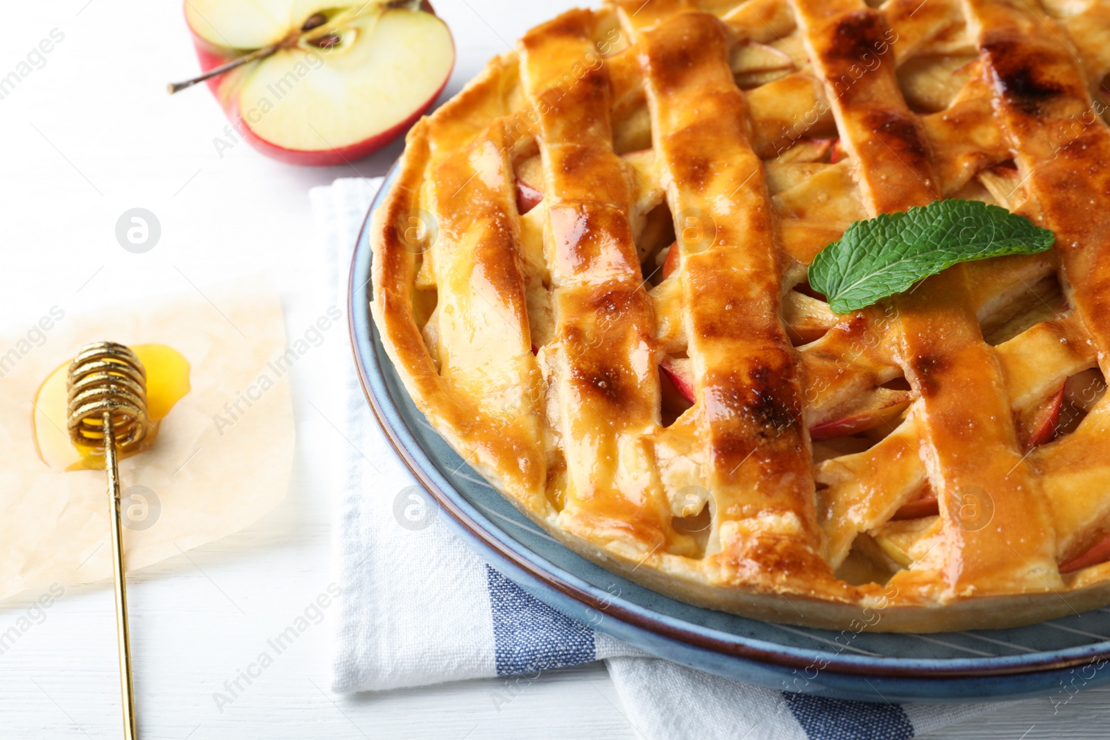 Photo of Fresh traditional apple pie on white table, closeup