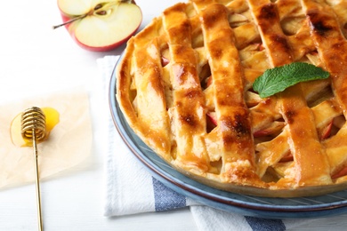 Fresh traditional apple pie on white table, closeup