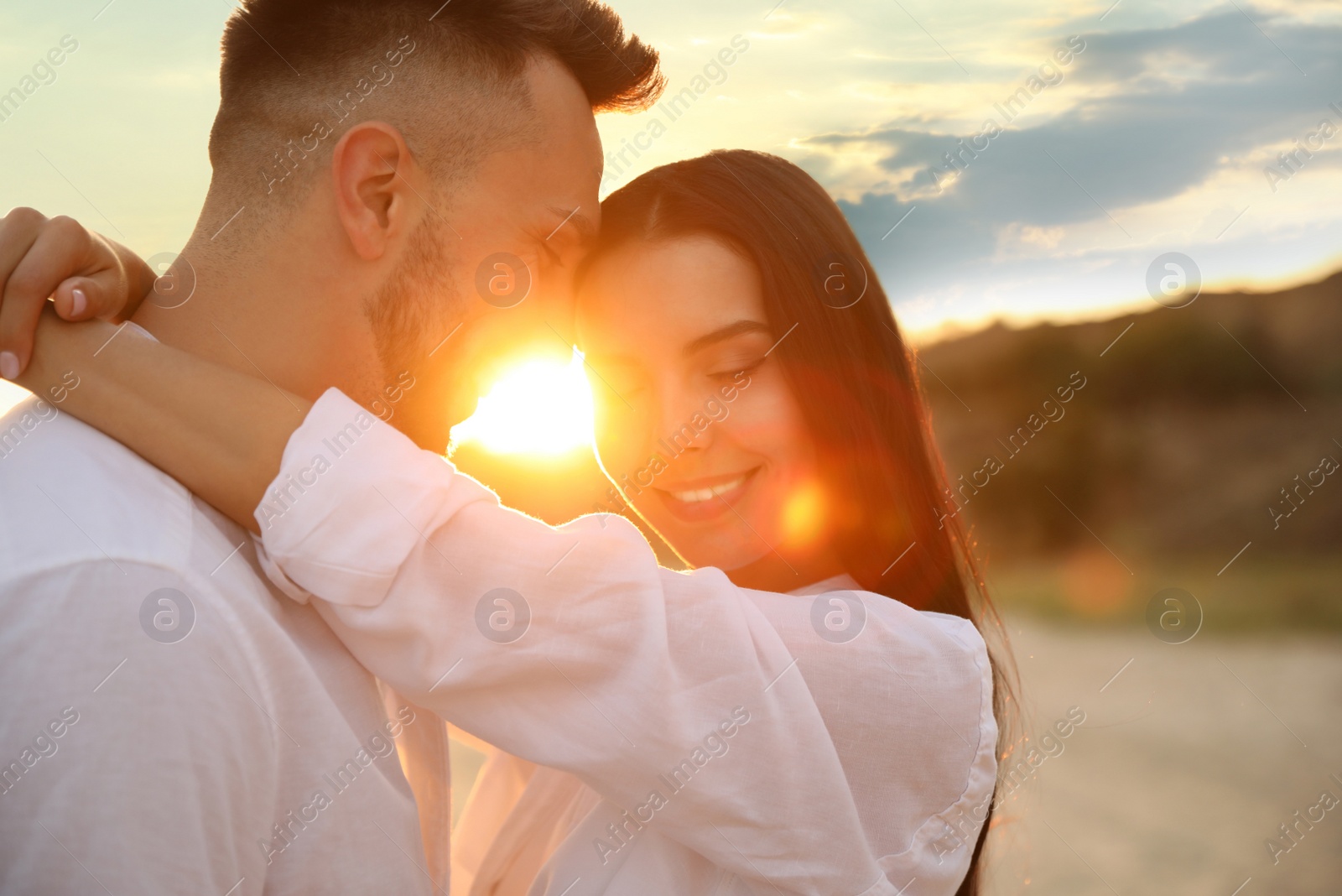 Photo of Happy young couple on beach at sunset