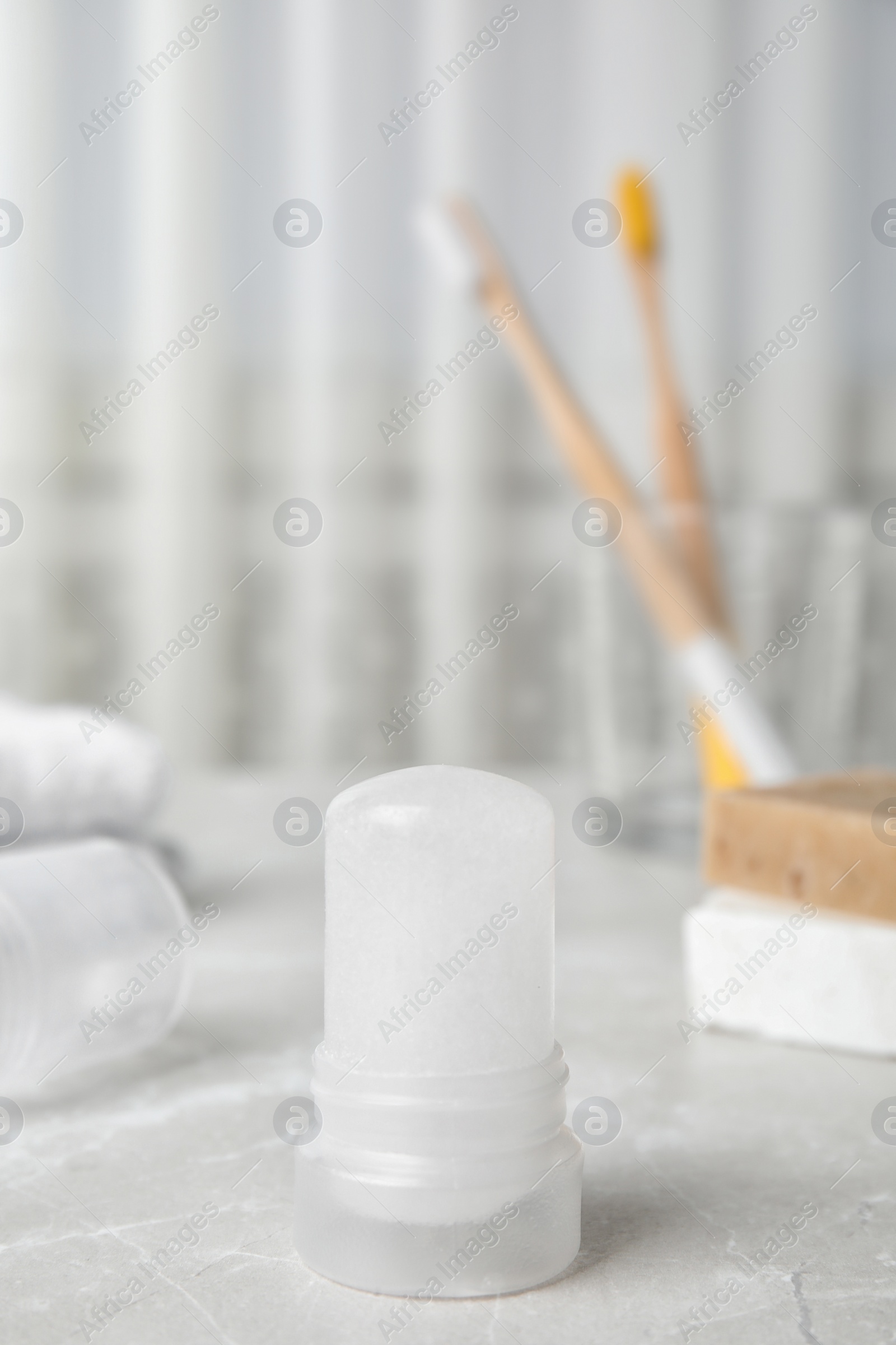 Photo of Natural crystal alum deodorant on light grey marble background