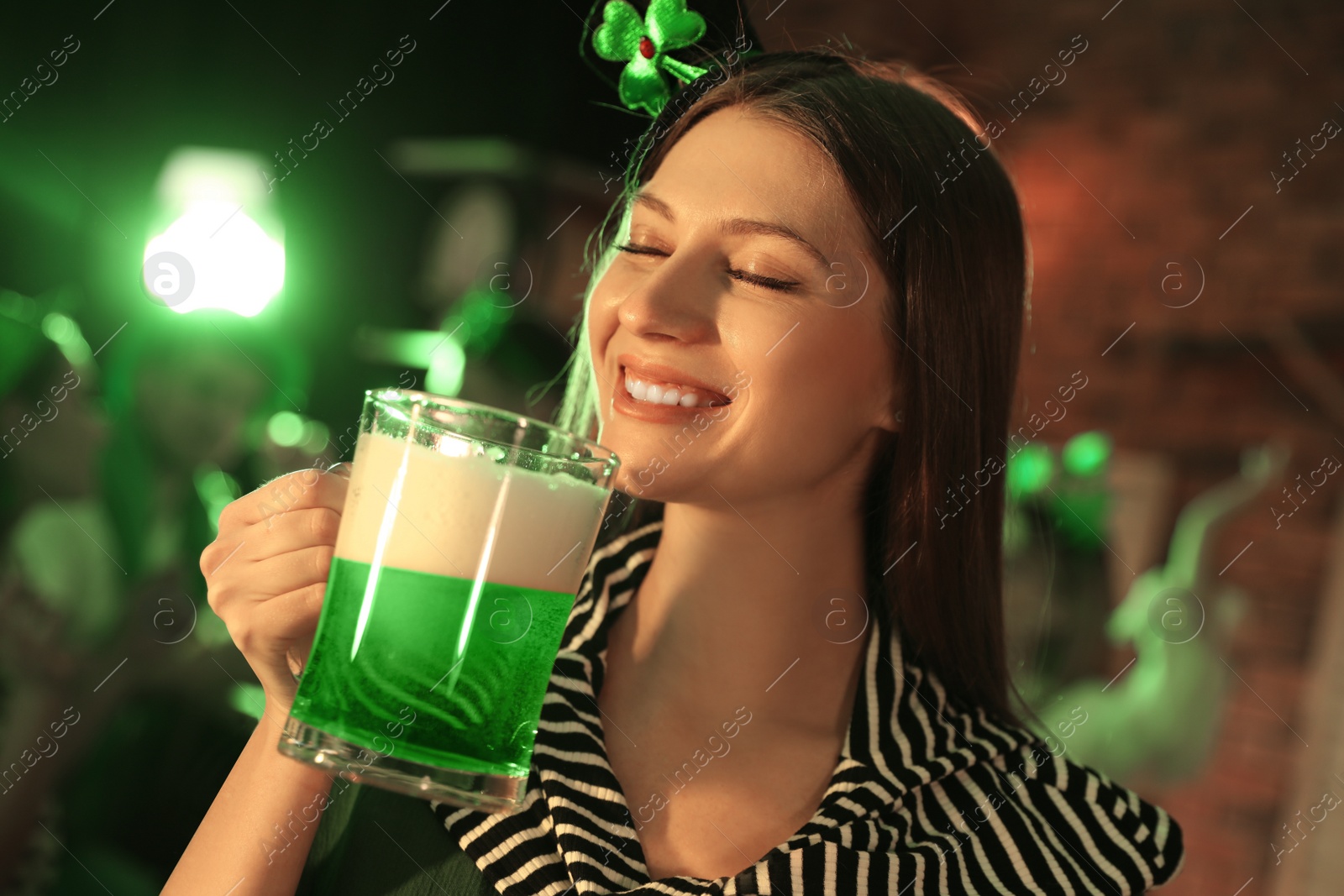 Photo of Woman with beer celebrating St Patrick's day in pub