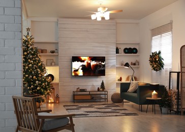 Plasma TV on white wooden wall in living room beautifully decorated for Christmas