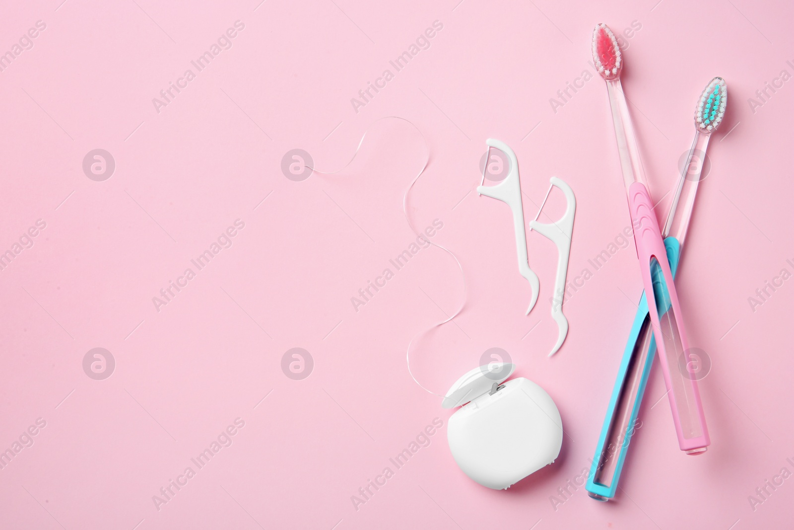 Photo of Flat lay composition with manual toothbrushes and oral hygiene products on color background