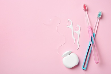 Flat lay composition with manual toothbrushes and oral hygiene products on color background