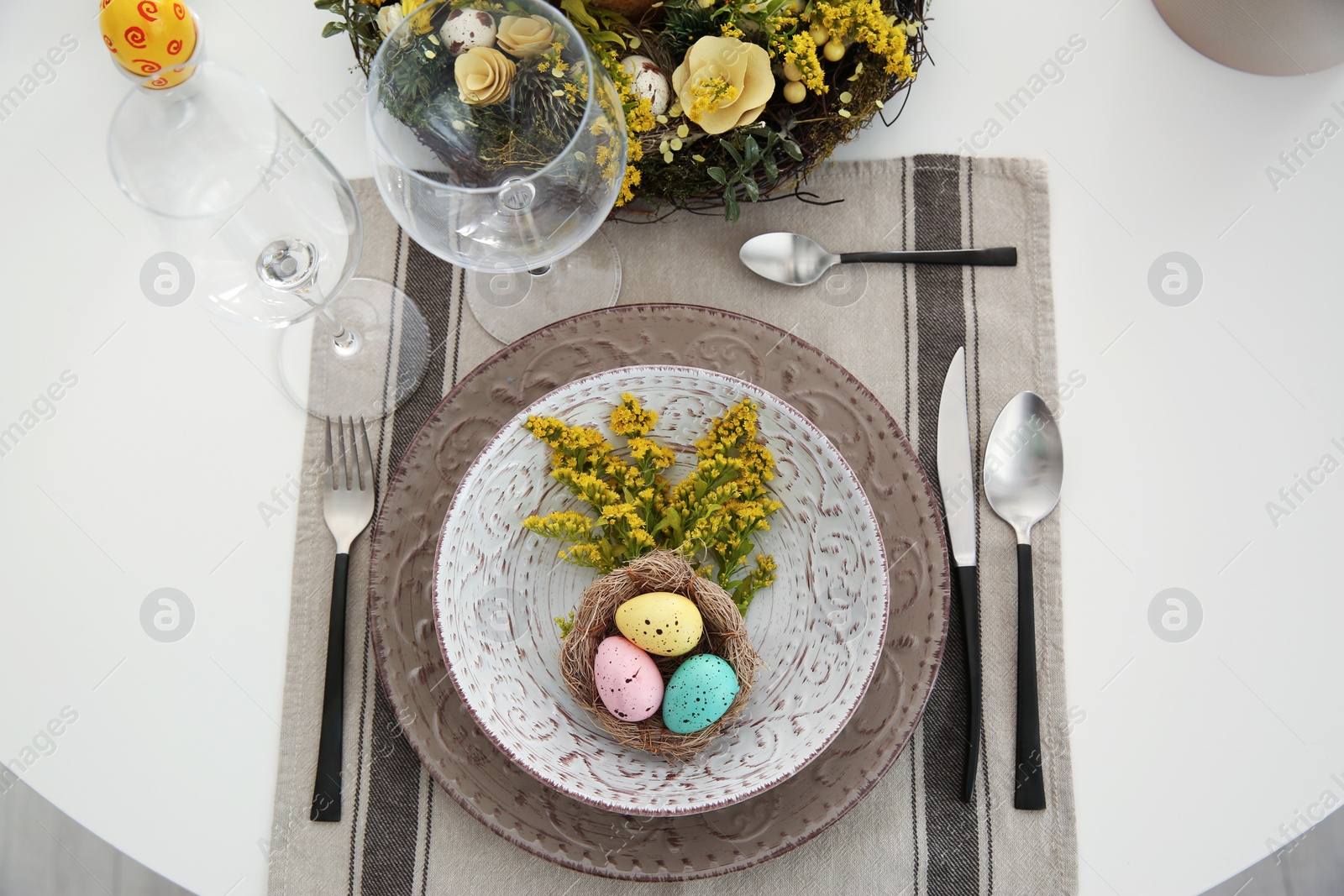 Photo of Festive Easter table setting with beautiful floral decor and eggs, flat lay