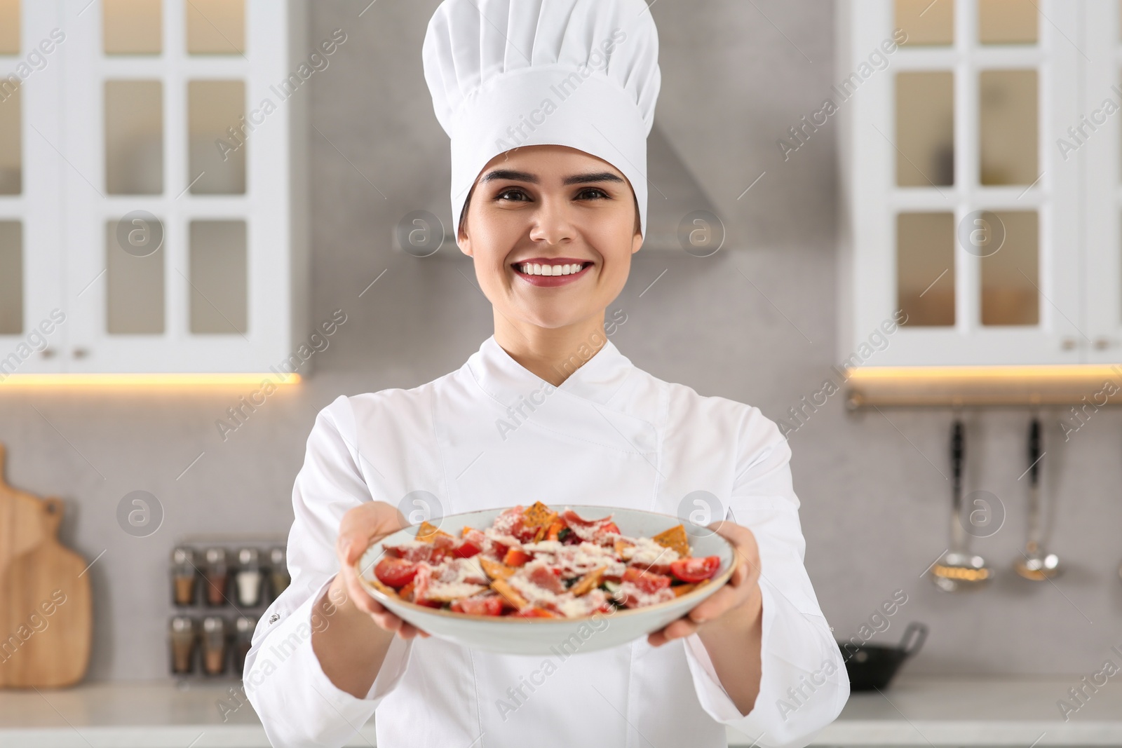 Photo of Portrait of professional chef presenting delicious dish in kitchen