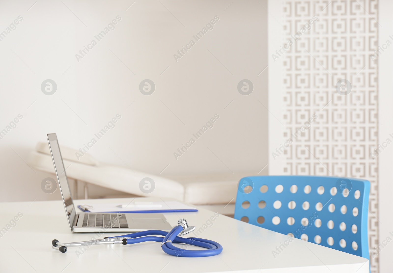 Photo of Doctor's workplace with modern laptop in medical office