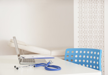 Doctor's workplace with modern laptop in medical office