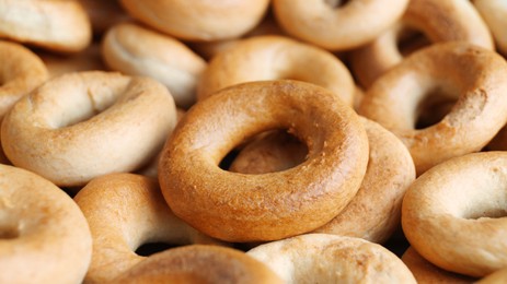 Photo of Tasty dry bagels (sushki) as background, closeup