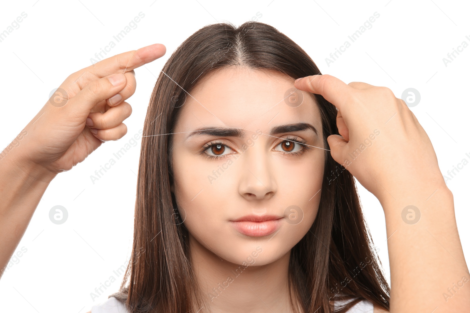 Photo of Young woman having eyebrow correction procedure on white background