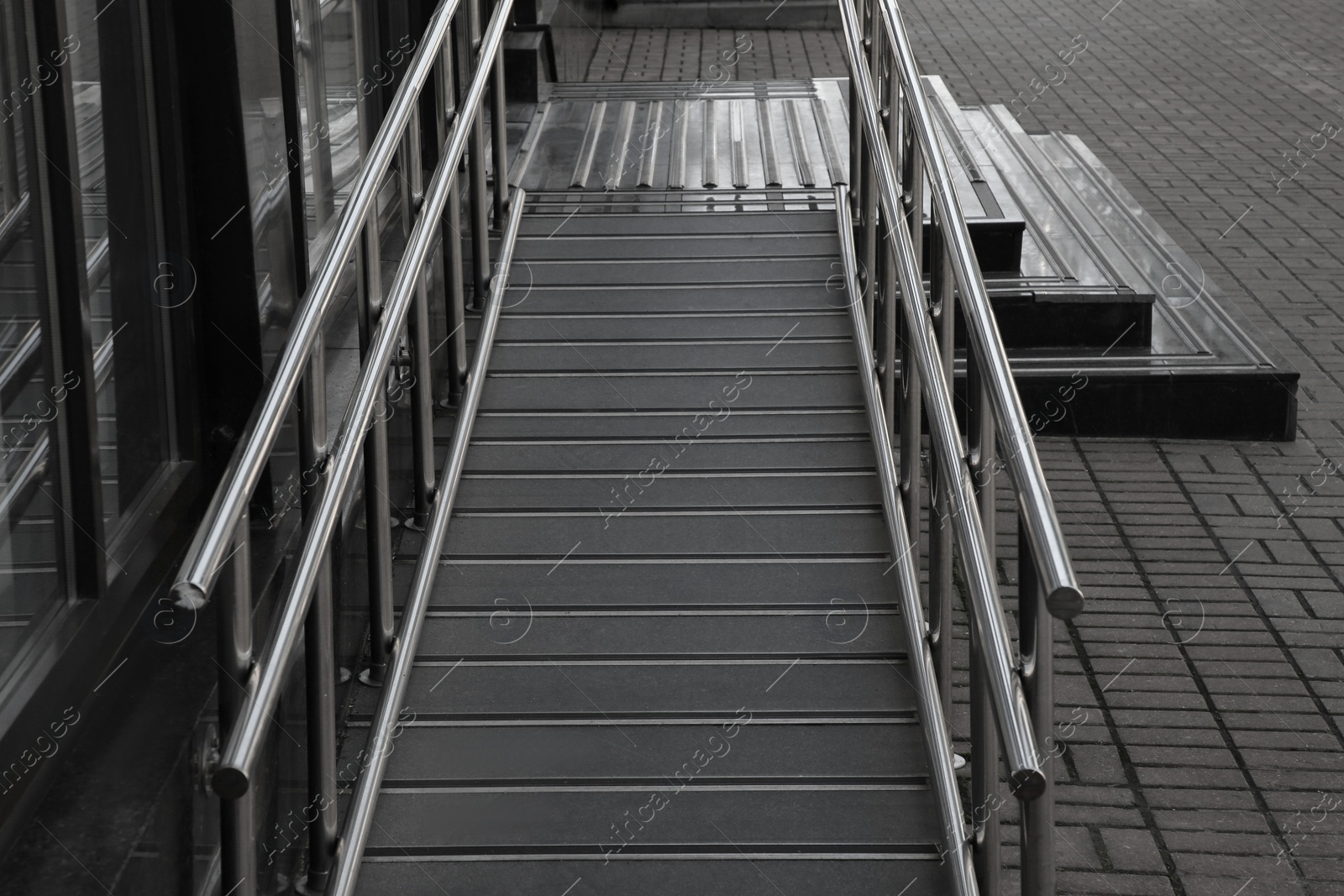 Photo of Ramp with metal railings near building outdoors