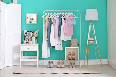 Photo of Stylish dressing room interior with clothes rack