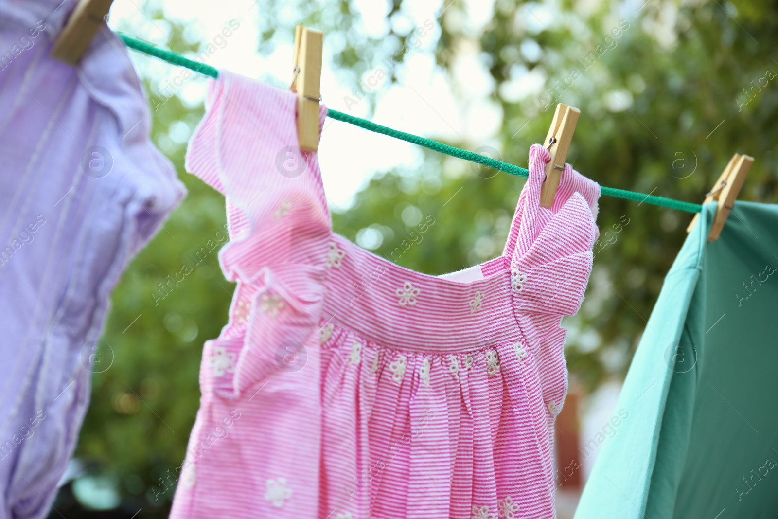 Photo of Clothes on laundry line outdoors on sunny day