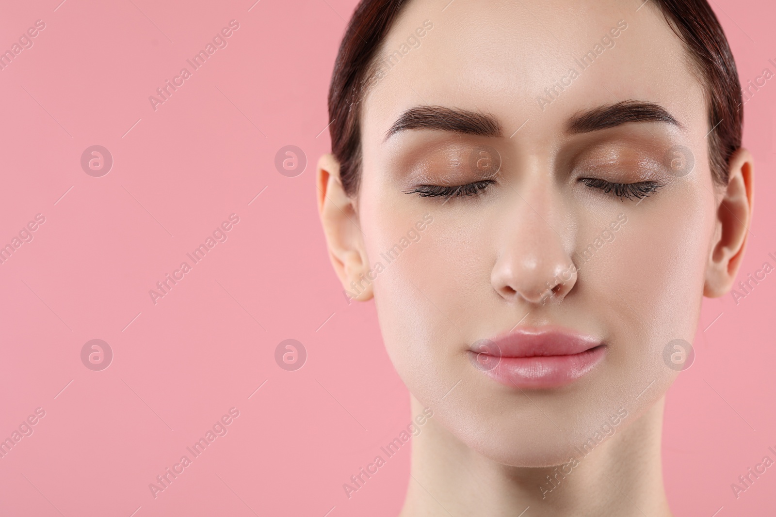 Photo of Beautiful young woman with healthy skin on pink background, closeup. Space for text