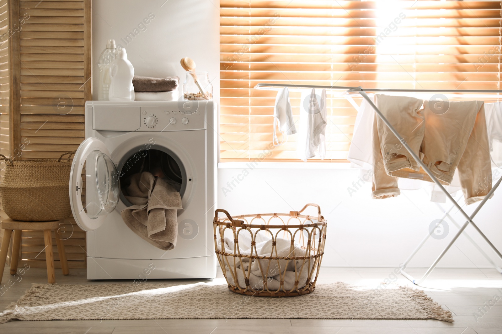 Photo of Stylish room interior with washing machine. Design idea