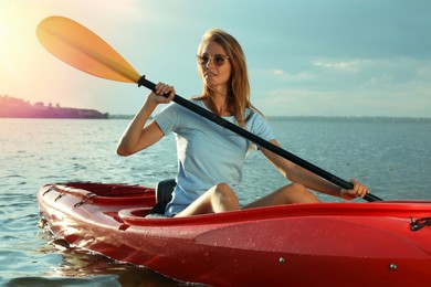Photo of Beautiful woman kayaking on river. Summer activity