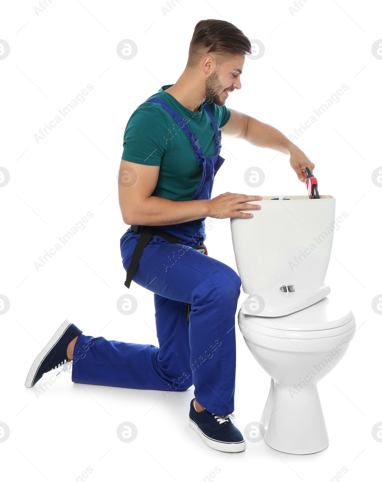 Photo of Young man working with toilet tank, isolated on white