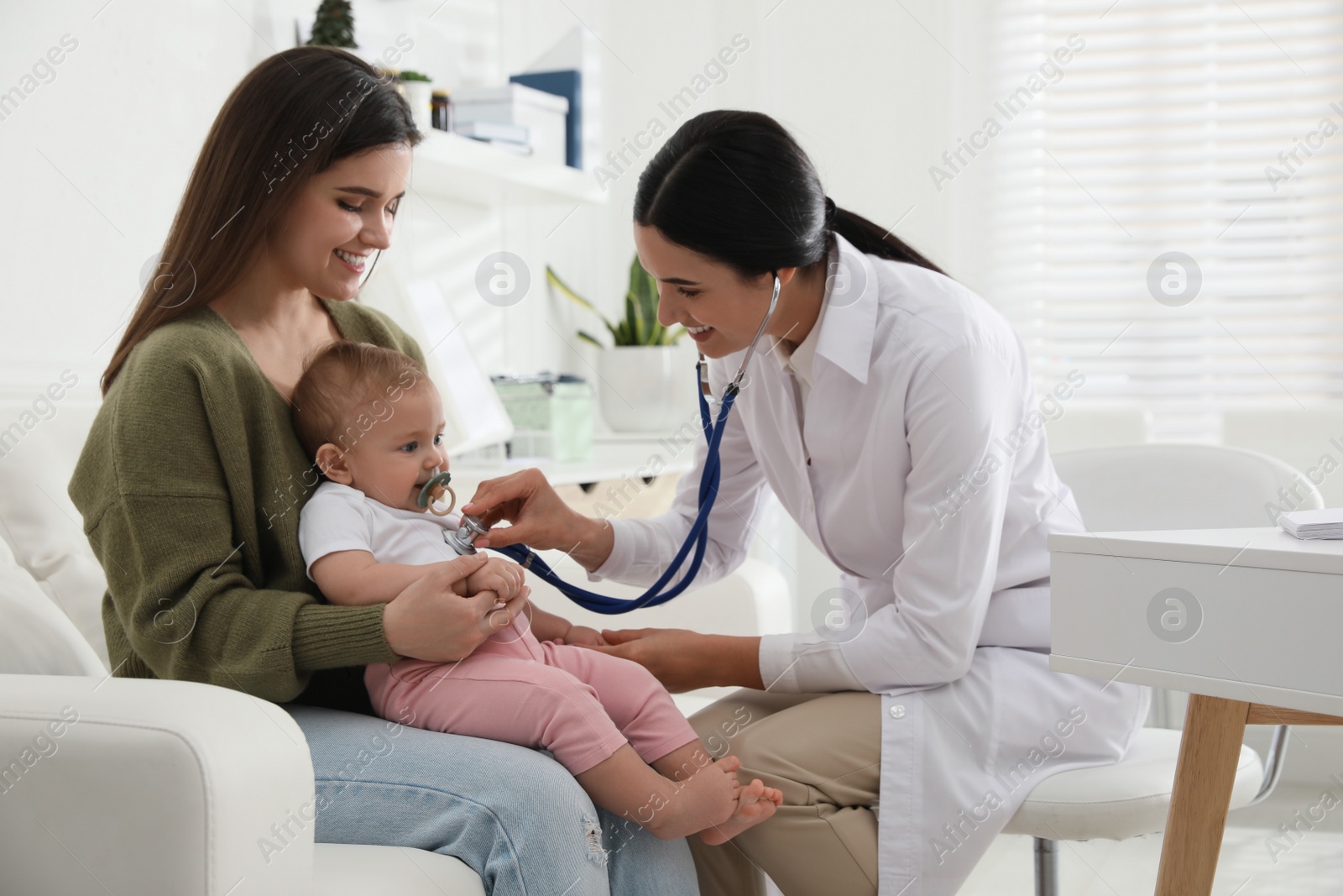 Photo of Mother with her cute baby visiting pediatrician in clinic