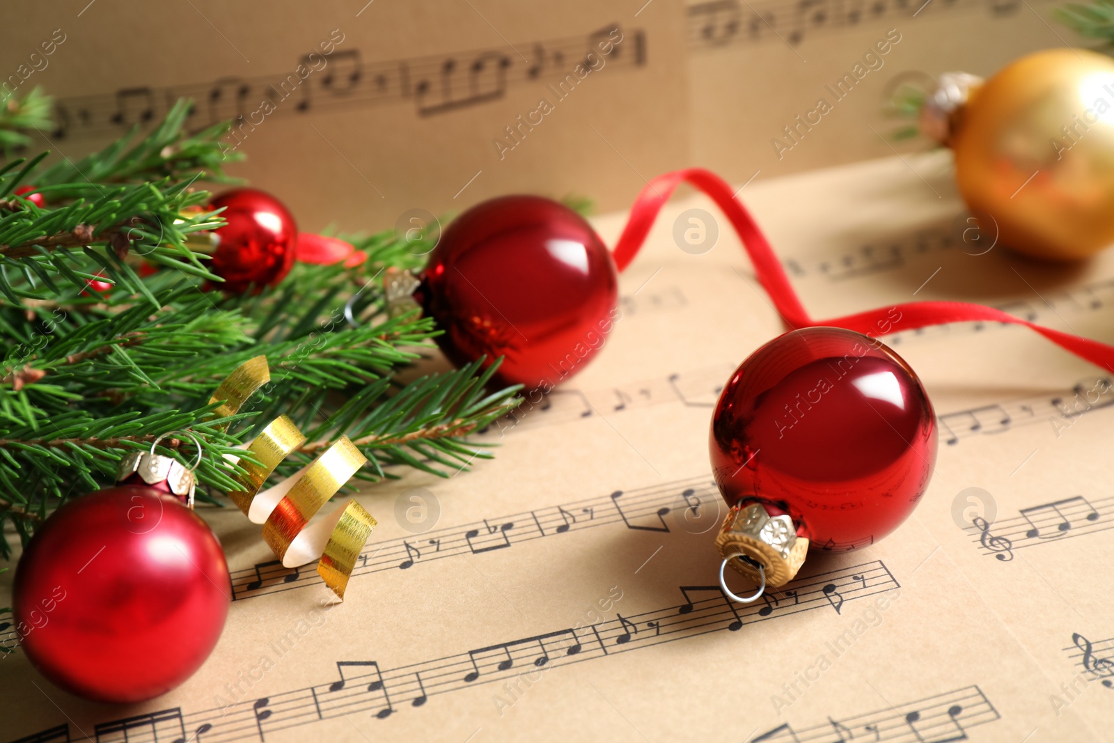 Photo of Composition with Christmas decorations on music sheets, closeup