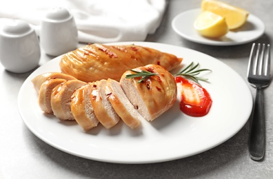 Fried chicken breast served with sauce on plate