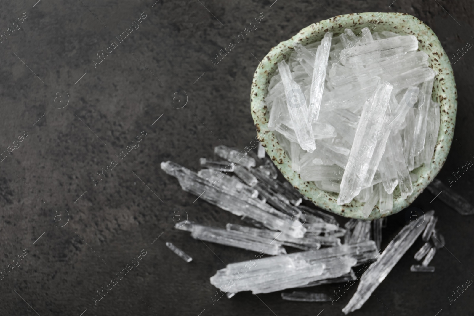 Photo of Menthol crystals on grey background, flat lay. Space for text