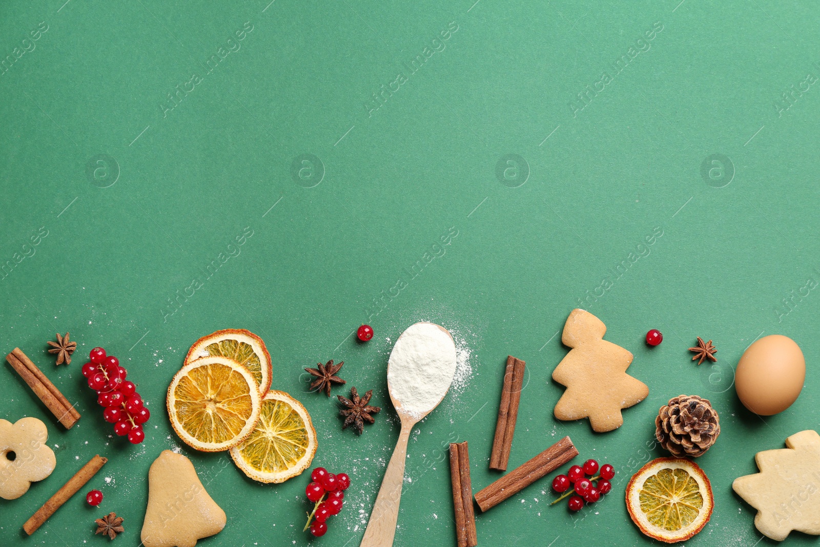 Photo of Flat lay composition with Christmas cookies and flour on green background. Space for text