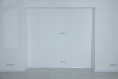 Niche on white wall in empty renovated room
