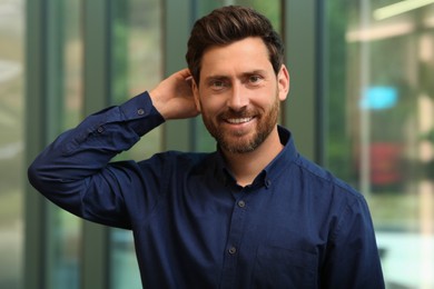 Photo of Portrait of handsome stylish man in office