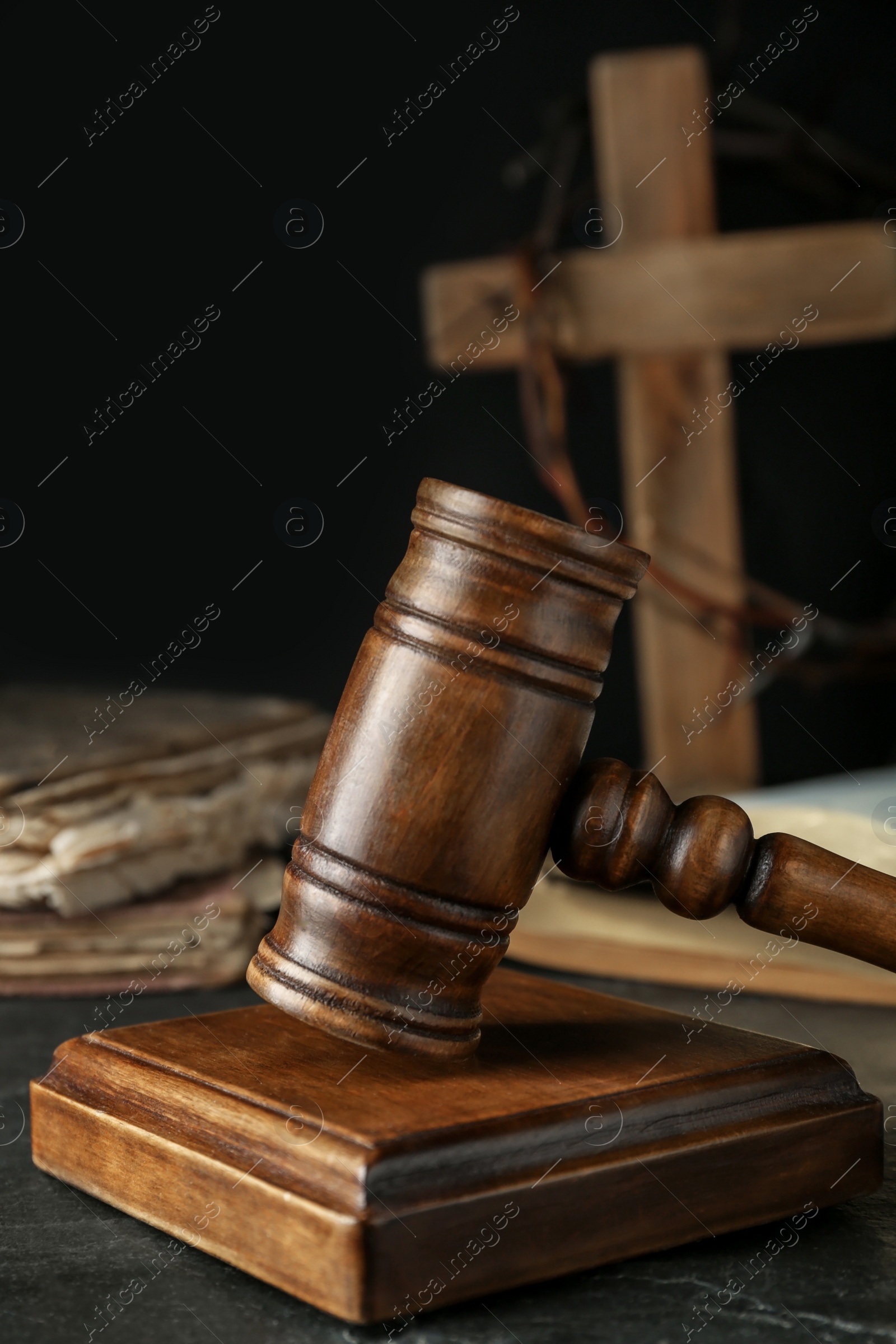 Photo of Wooden judge gavel on black table, closeup