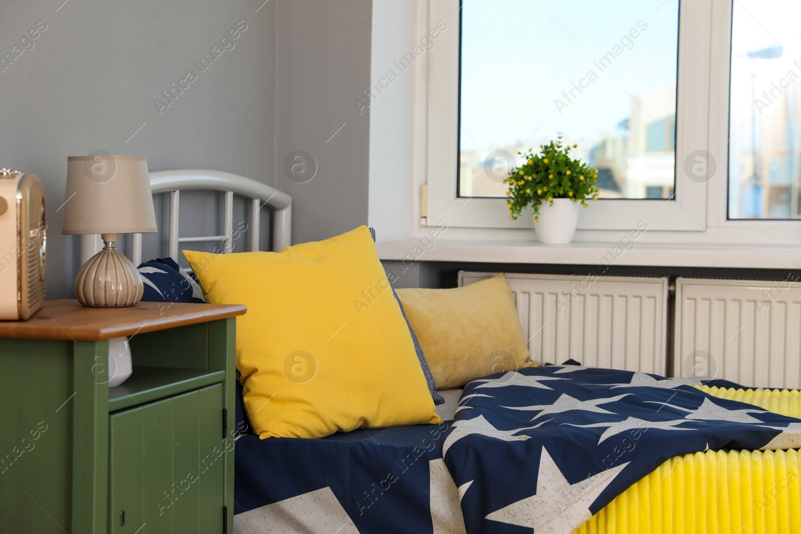 Photo of Stylish child room interior with comfortable bed near window