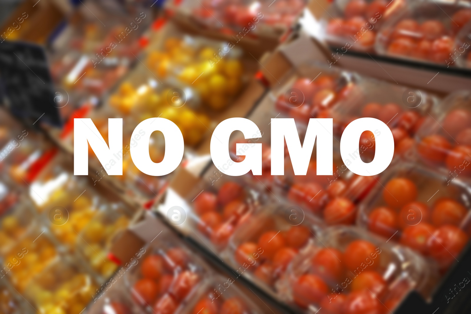 Image of GMO free products. Blurred view of fresh ripe tomatoes on counter at wholesale market