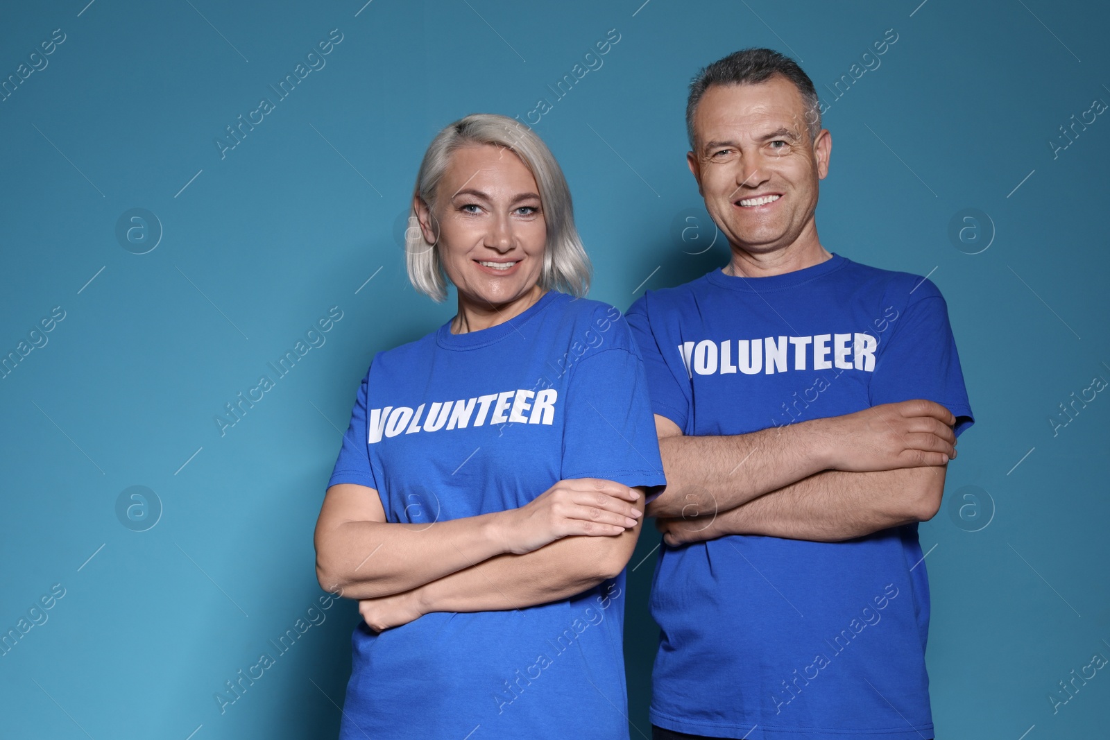 Photo of Portrait of volunteers in uniform on blue background