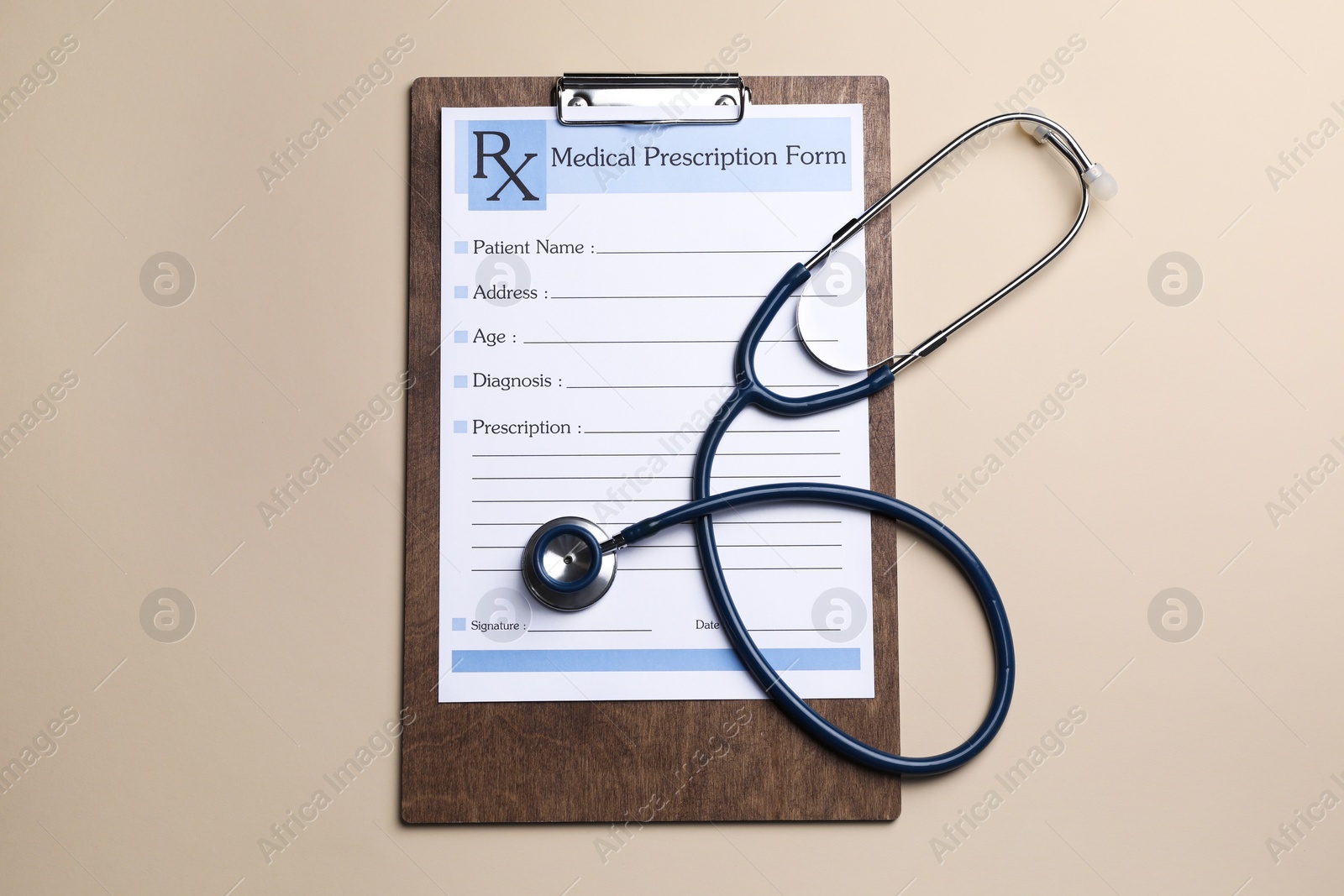 Photo of Clipboard with medical prescription form and stethoscope on beige background, flat lay