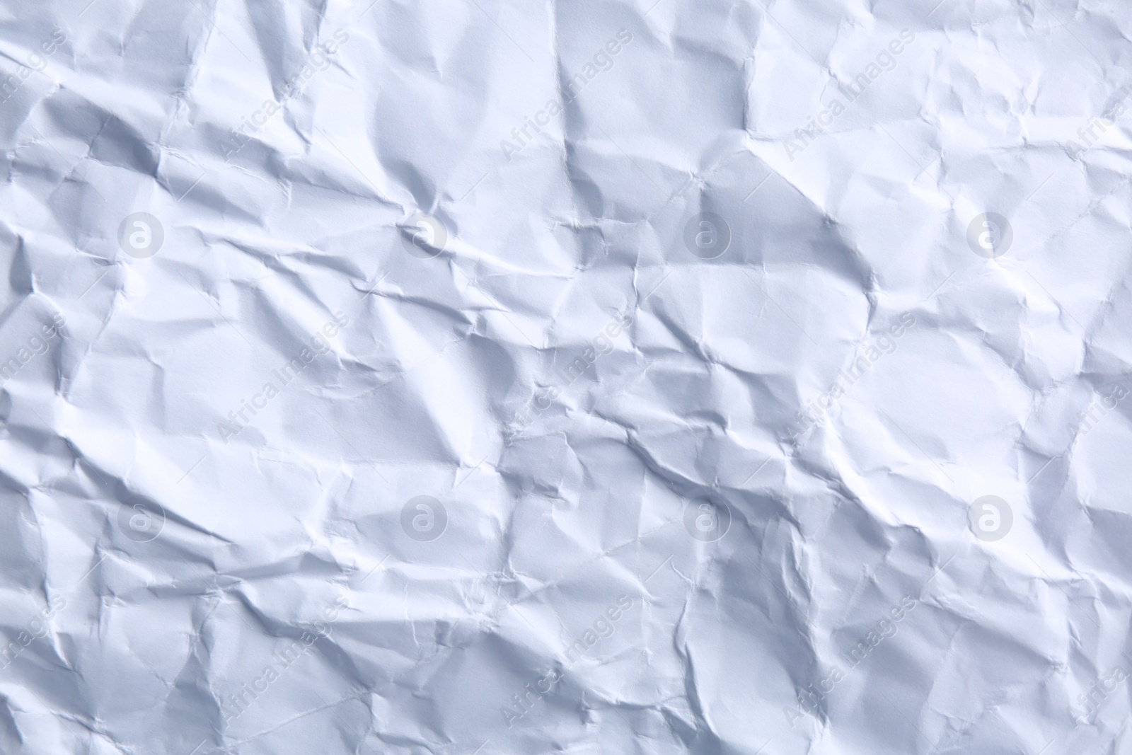 Photo of Crumpled sheet of paper as background, closeup